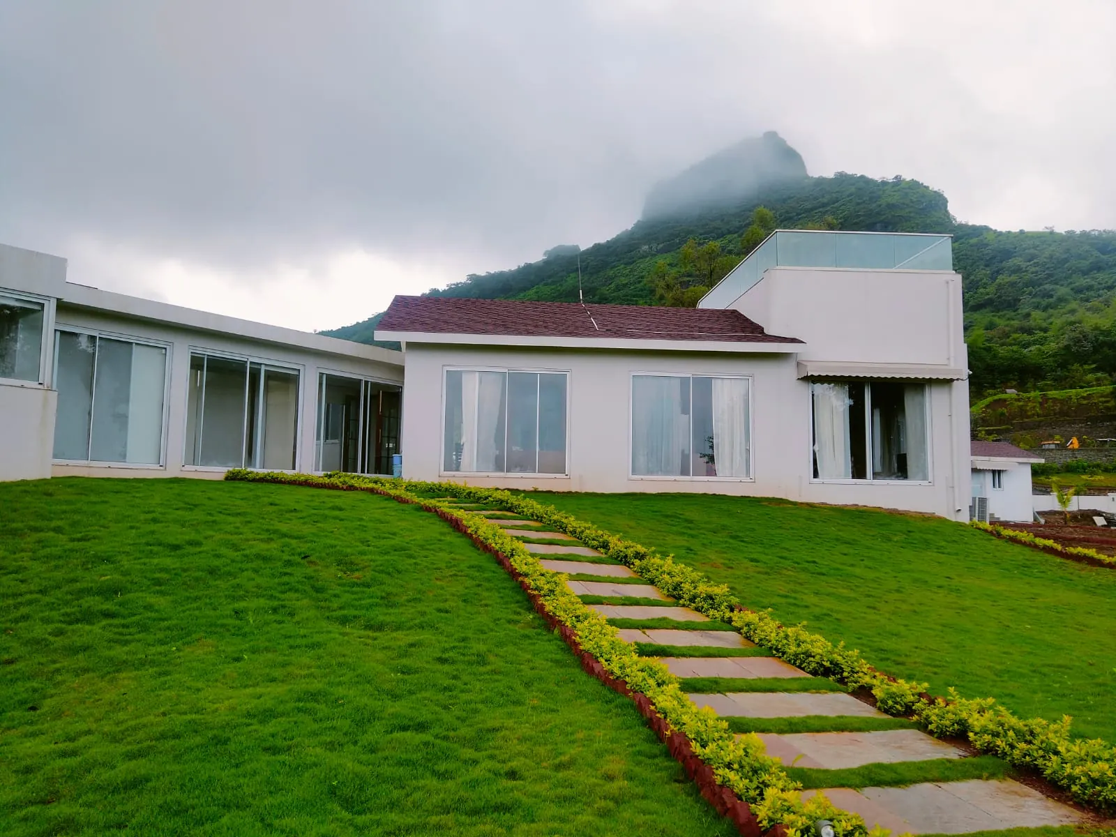 Garden path to the house during the monsoon, with the fort above